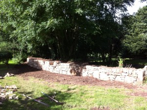 Wall finished Granite and mess cleared away, topsoiled and seeded