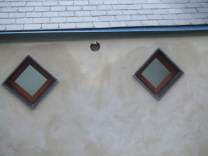 Lime render on block with slate sills.