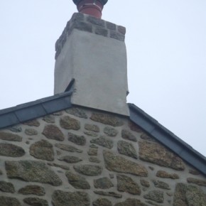 Lime render to stabilize and waterproof and old chimney. Extra courses of Portuguese granite added.