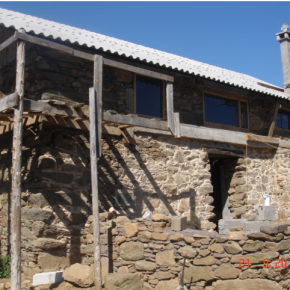 The extension was built in block and faces in natural stone .Then butted into a cast concrete lintel that was used to stabilise the leaning lower wall.