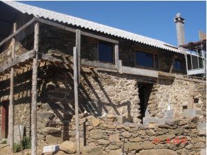 The extension was built in block and faces in natural stone .Then butted into a cast concrete lintel that was used to stabilise the leaning lower wall.