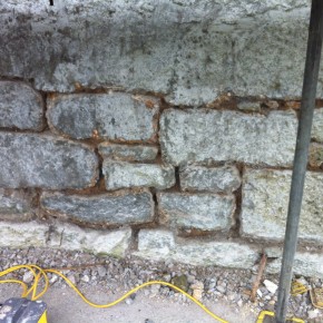 Because the wall had been pointed with waterproof pointing and then tanked with a cement slurry. It made it necessary to remove the pointing to allow the building to breath.